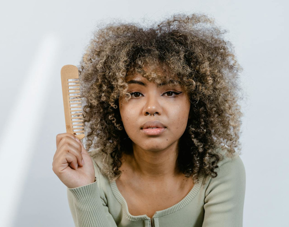 curly hair black woman with comb